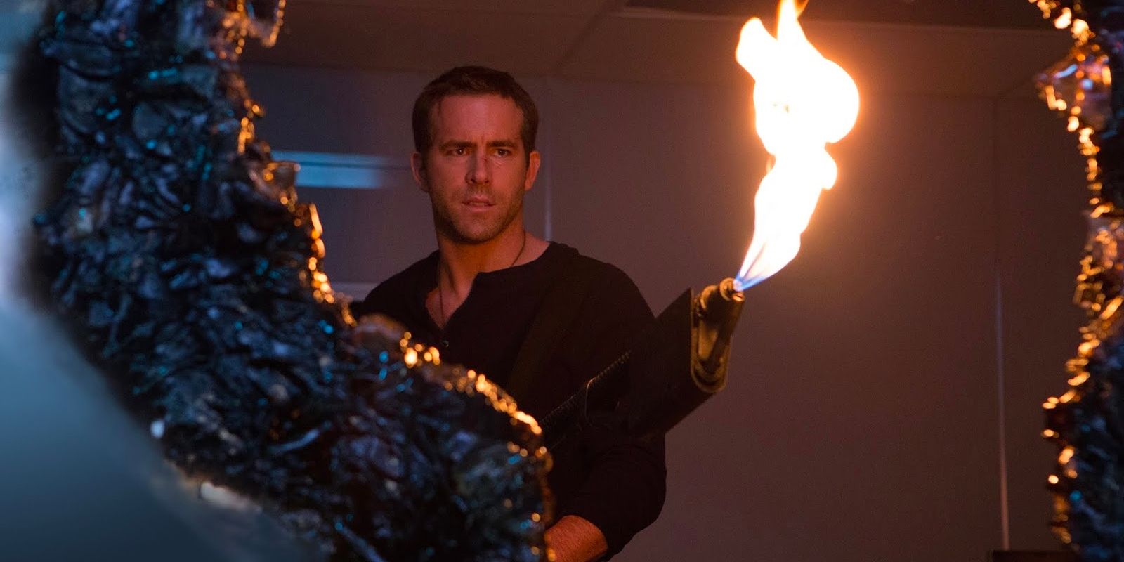 Ryan Reynolds holding a flamethrower in &lsquo;Self/less&rsquo;