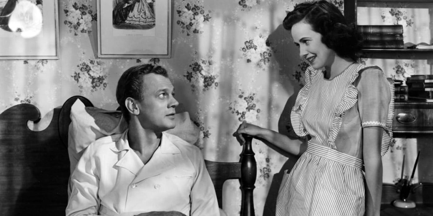 Joseph Cotten sits up in bed as Teresa Wright stands next to him in Shadow of a Doubt