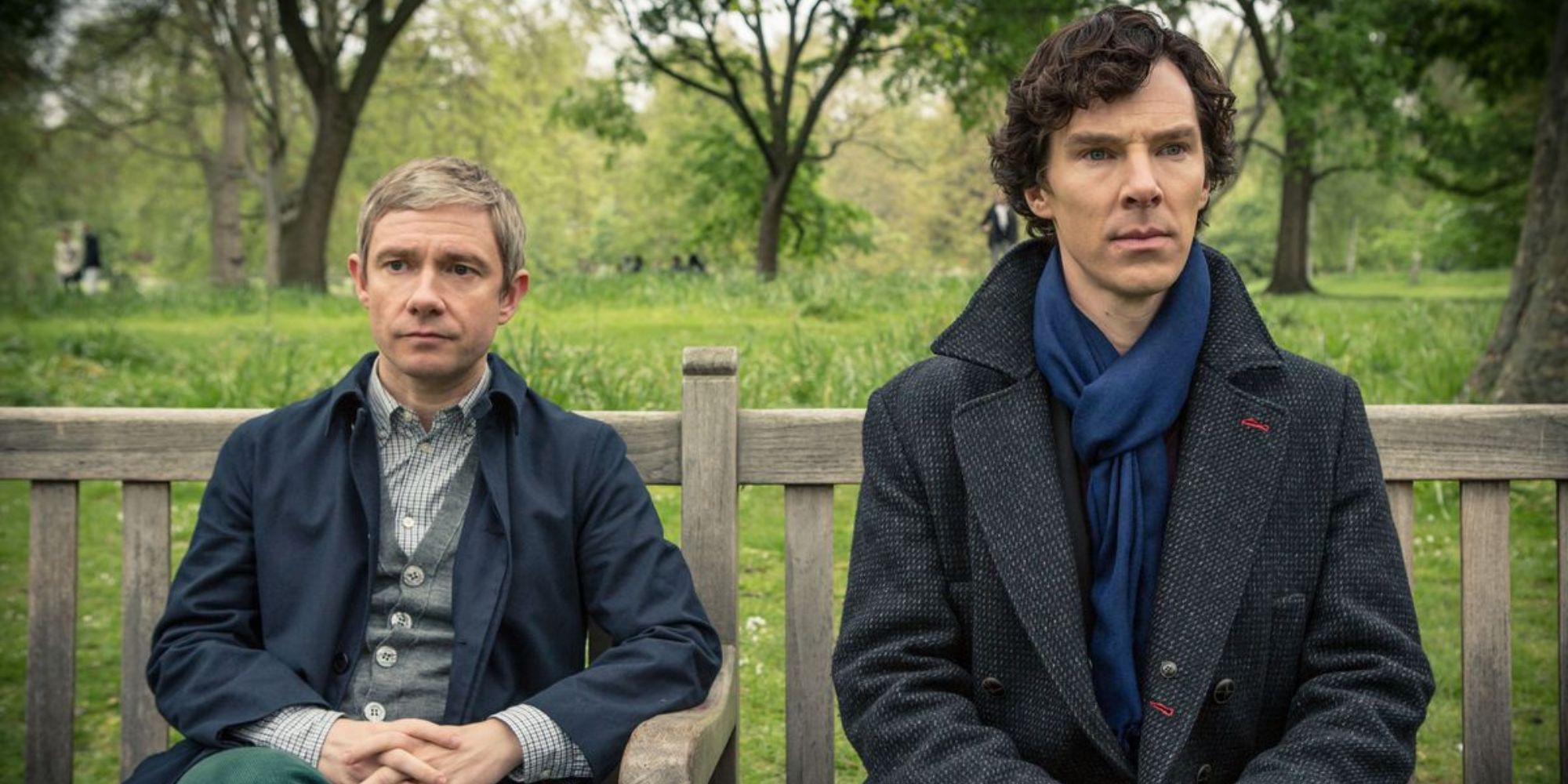 Dr. John Watson and Sherlock Holmes from Sherlock sitting on a bench together