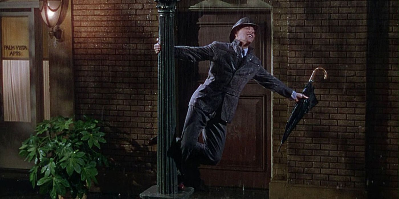 Gene Kelly swings around a lamppost while singing in the rain