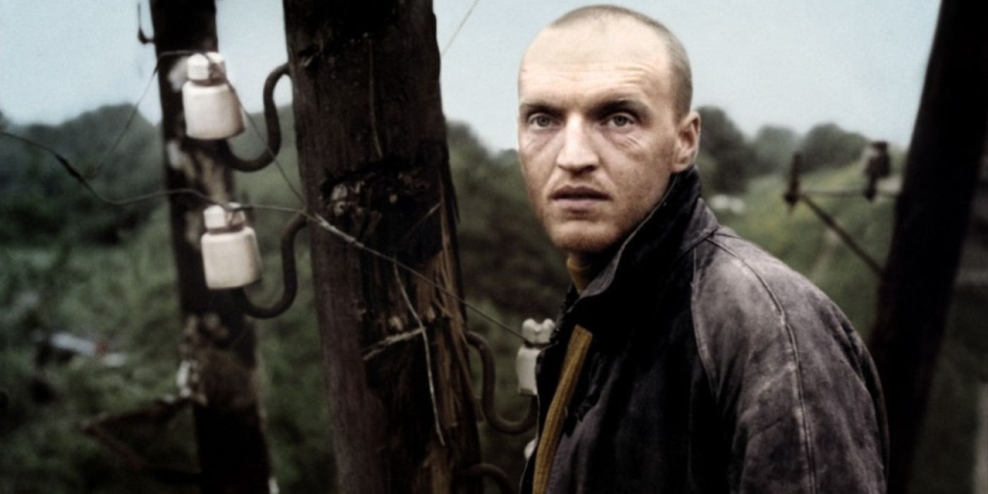 A man stands against a barren landscape in Stalker