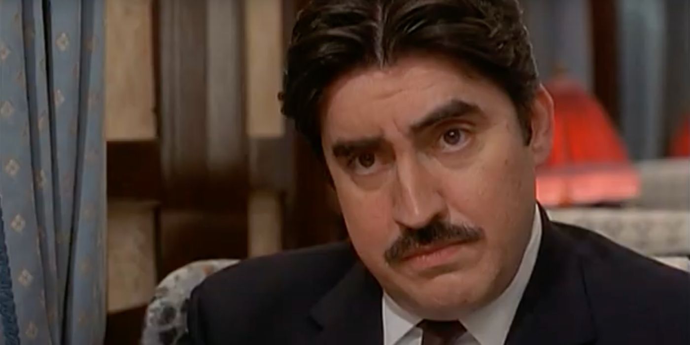 close-up of Alfred Molina sitting on a train in the 2001 TV movie, Murder on the Orient Express.