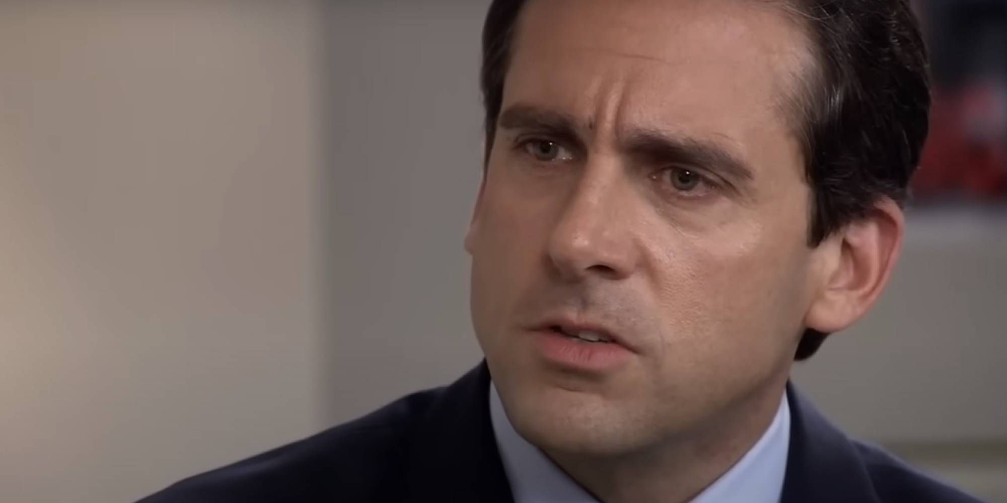 Steve Carrell as Michael Scott in The Office looking at Toby off-camera.