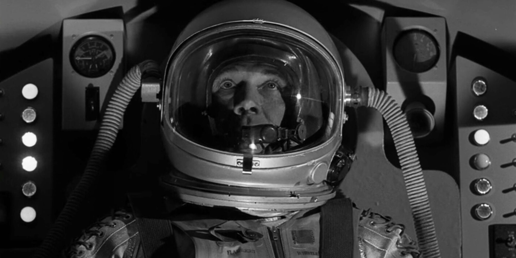 Steve Forrest wearing an astronaut uniform while sitting in a spacecraft in The Twilight Zone