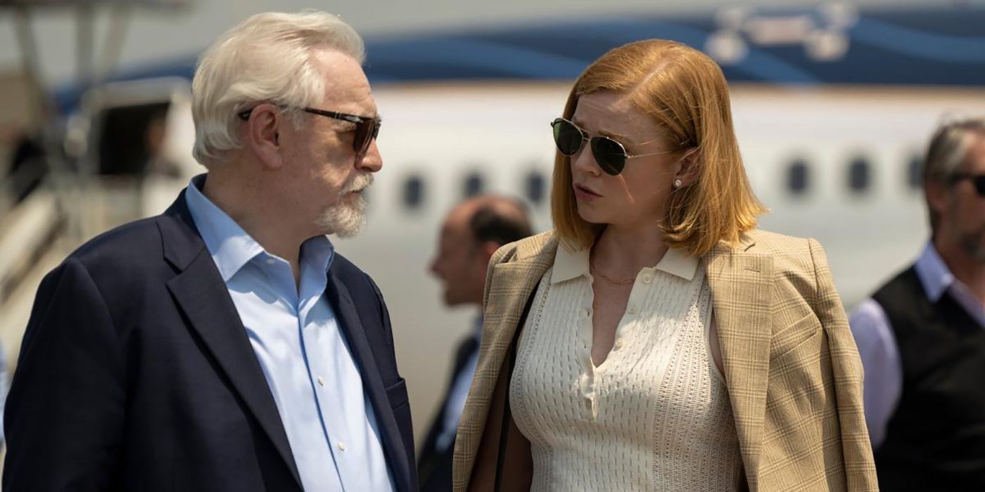 Logan and Shiv standing outside by a plane wearing sunglasses looking at one another in a scene from Succession.