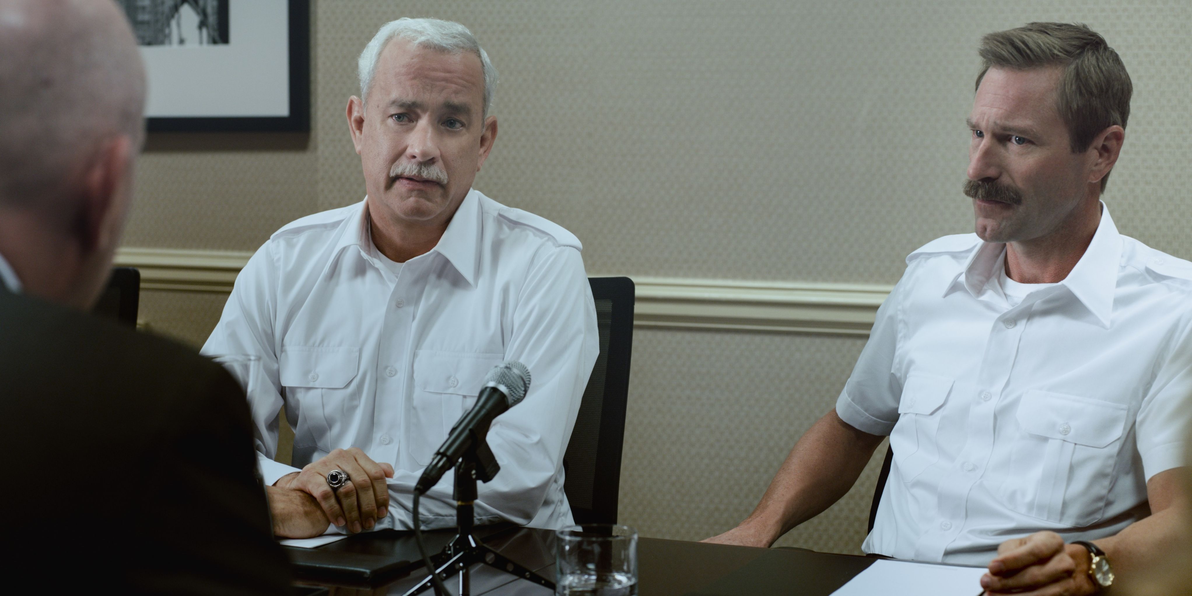 Sully (Tom Hanks) and Jeff (Aaron Eckhardt) being interviewed in Sully