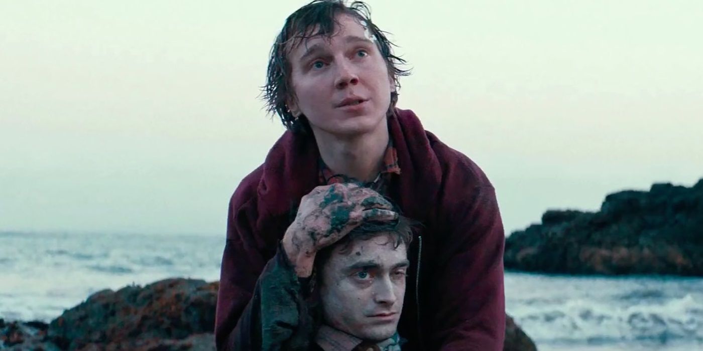 Paul Dano embracing Daniel Radcliffe on the shore in Swiss Army Man
