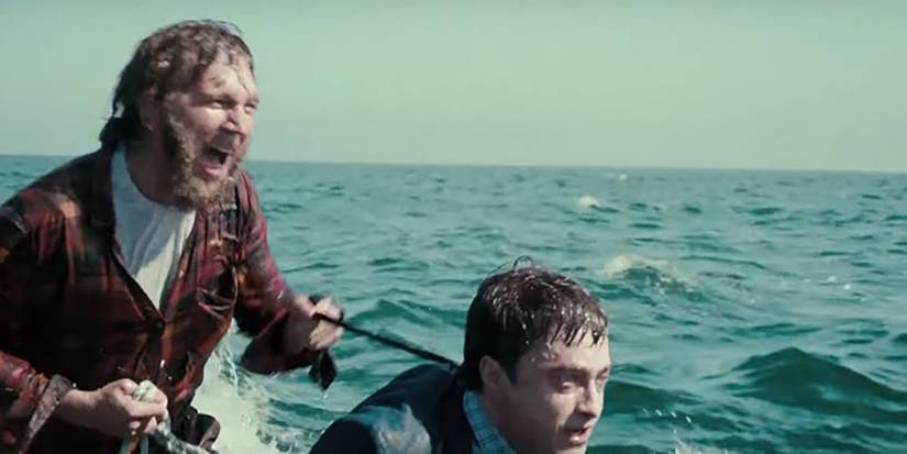 Hank (Paul Dano) using Manny (Daniel Radcliffe) to ride the waves in 'Swiss Army Man'