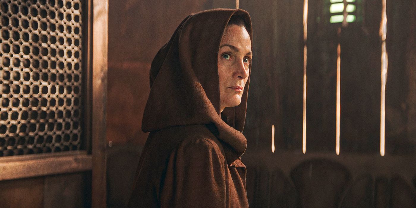 Carrie Anne Moss wearing a hooded cloak in The Acolyte