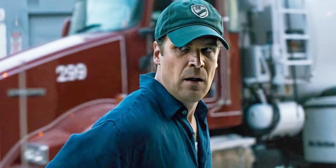 David Harbour as Frank Masters wearing a baseball cap and looking back in The Equalizer