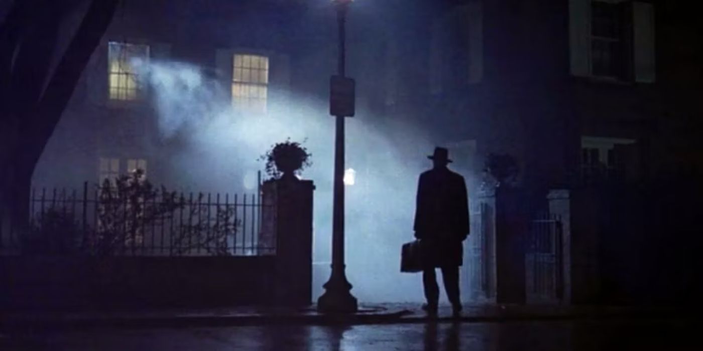 A man standing on a shadowy street at night in The Exorcist