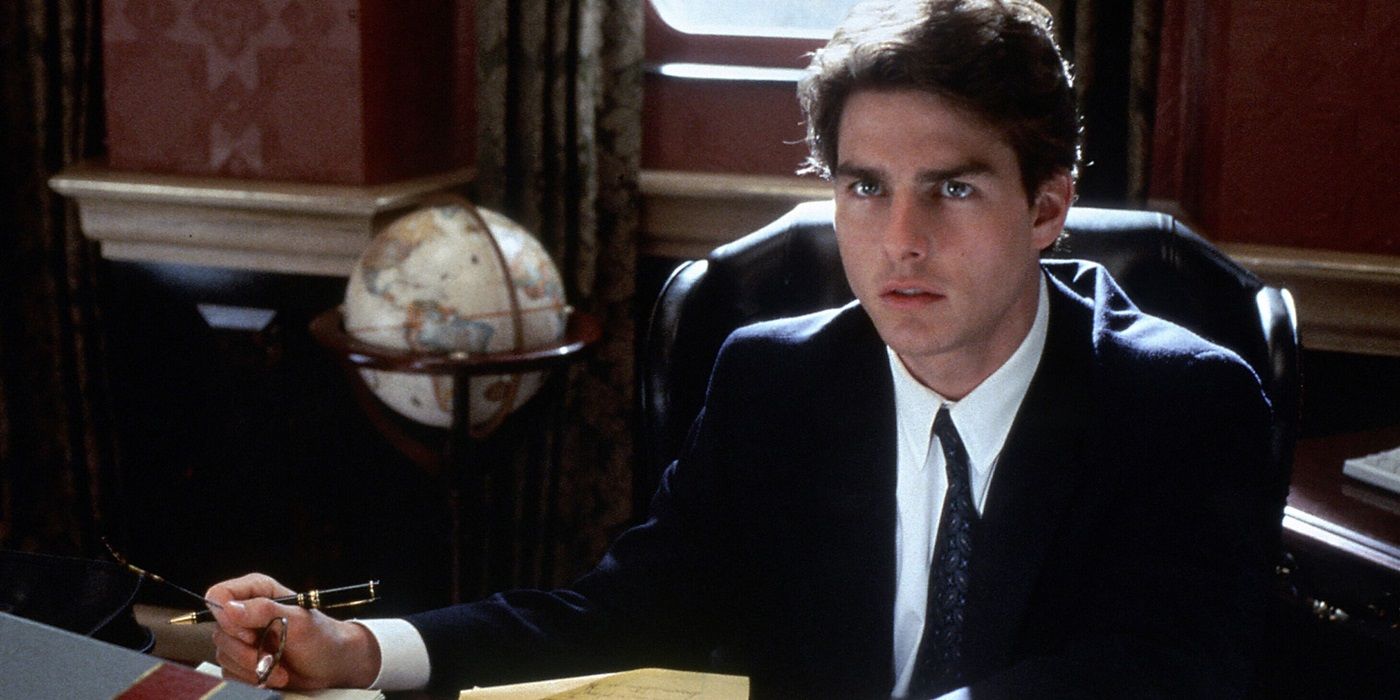 Tom Cruise as Mitch McDeere sitting in his office in The Firm