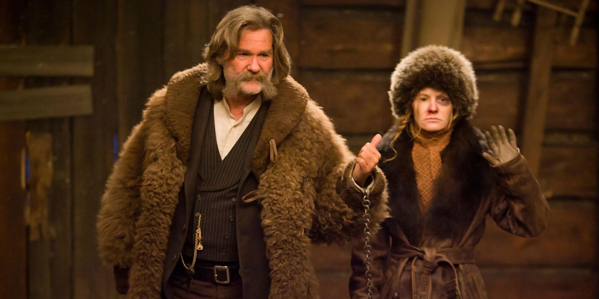 John "The Hangman" and "Crazy" Daisy walking into a cabin in The Hateful Eight