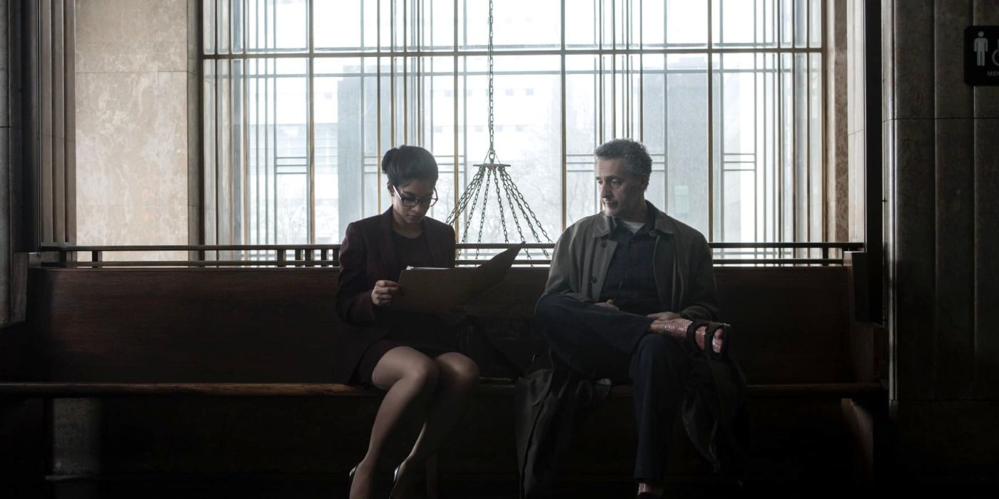 Amara Karan &amp; John Turturro as Chandra Kapoor &amp; John Stone looking over a file in a hallway in The Night Of.