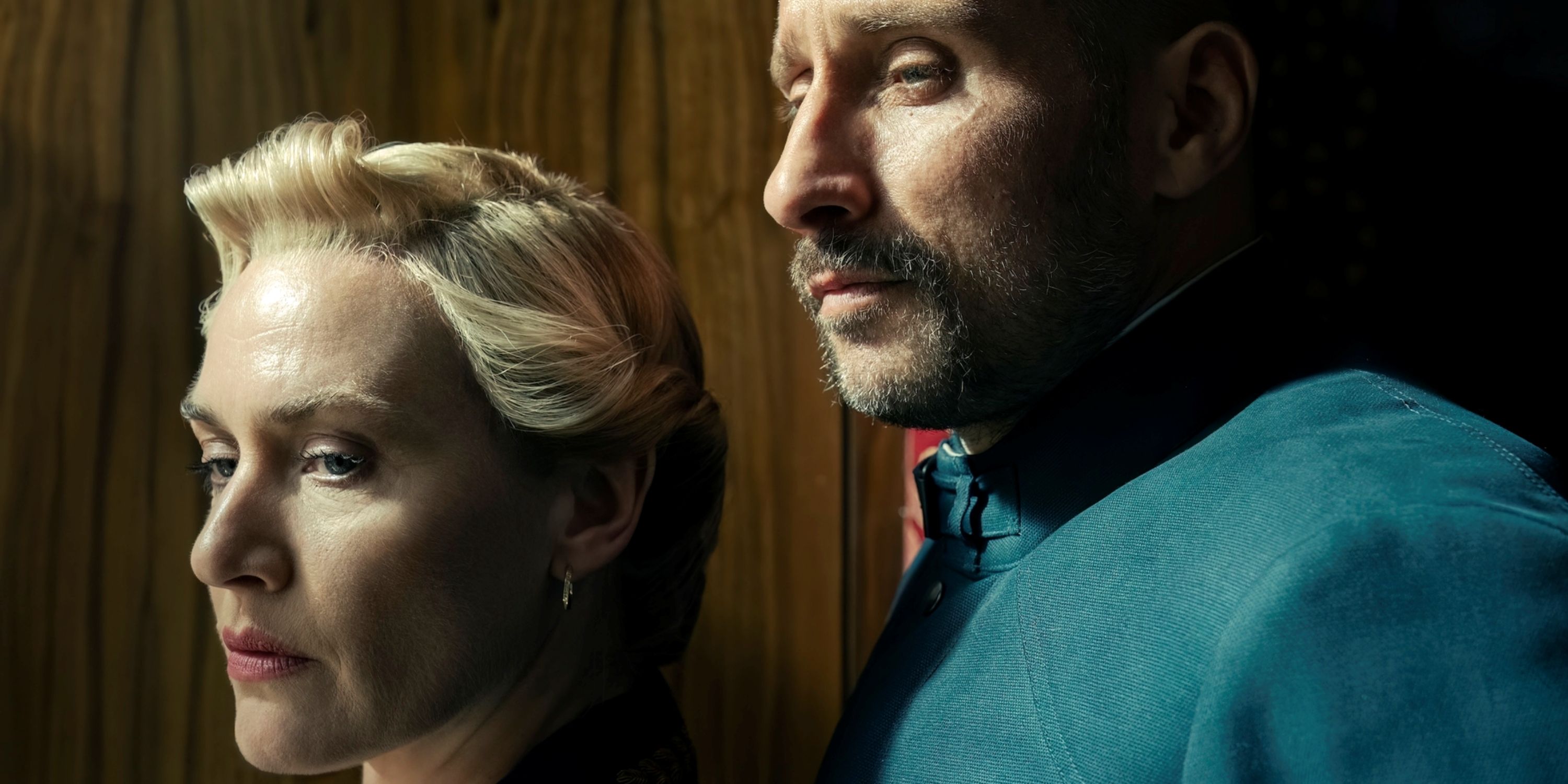 Matthias Schoenarts as Herbert Zuback with Kate Winslet in profile close-up in The Regime