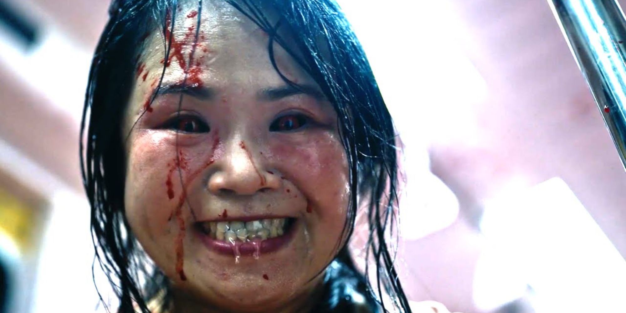 An infected woman smiling viciously in The Sadness (2021)