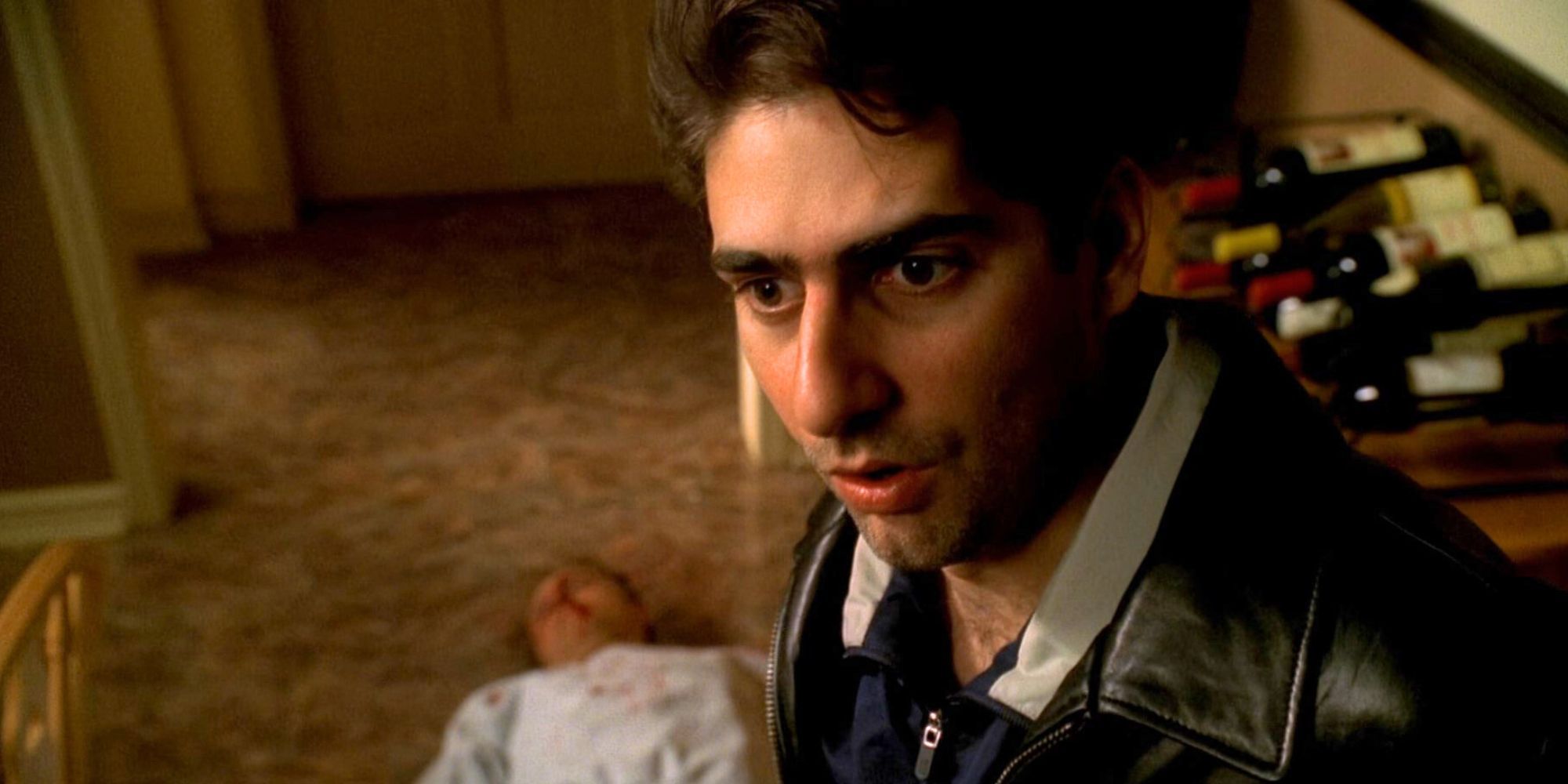 Michael Imperioli shocked with a dead body laying on the floor behind him in The Sopranos