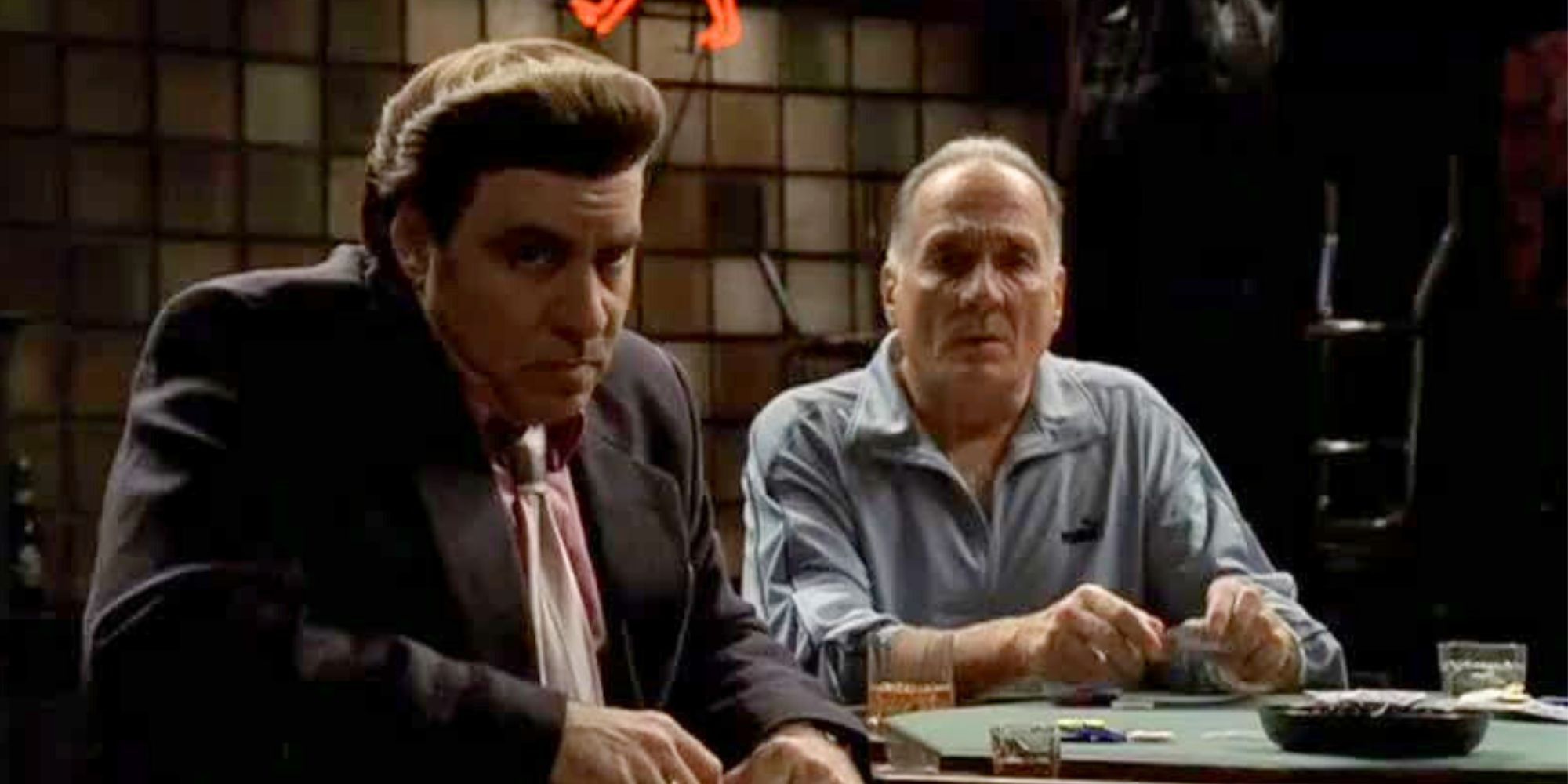 Steven Van Zandt sitting at a table next to Arthur J. Nasacarella in The Sopranos