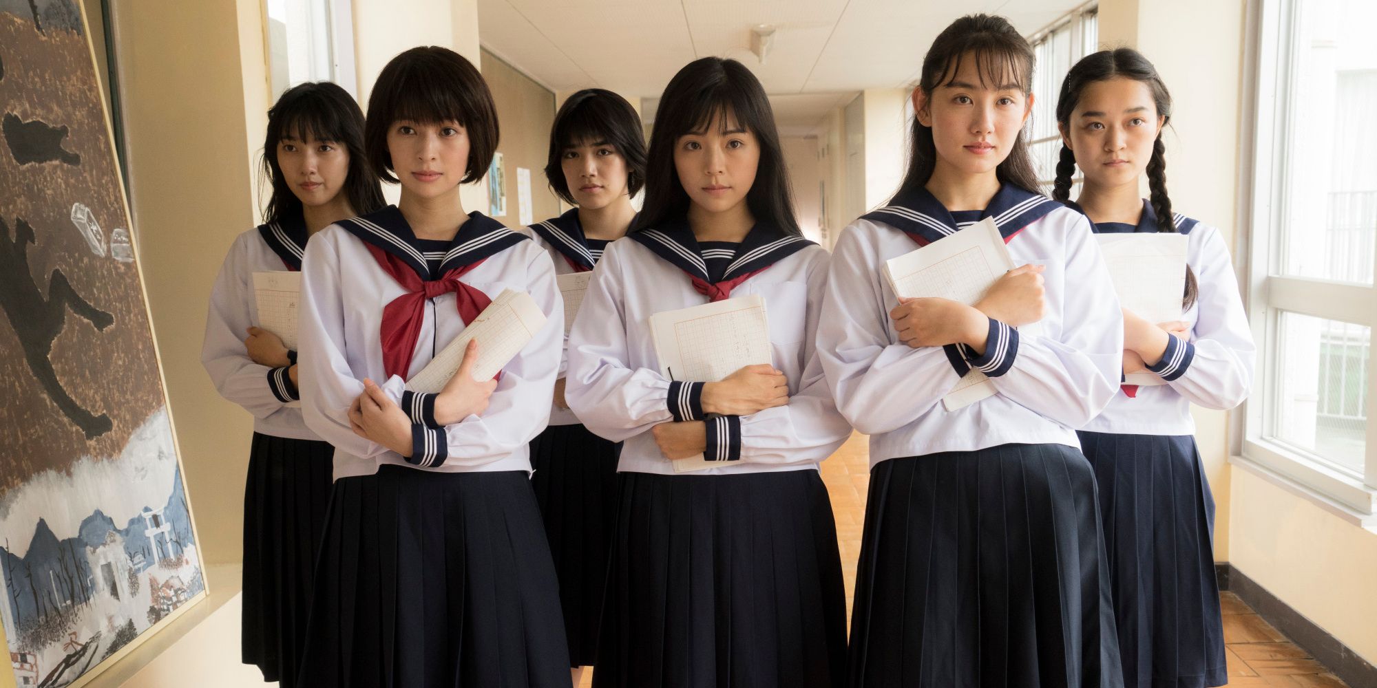 A still from The Forest of Love featuring a group of schoolgirls all holding papers