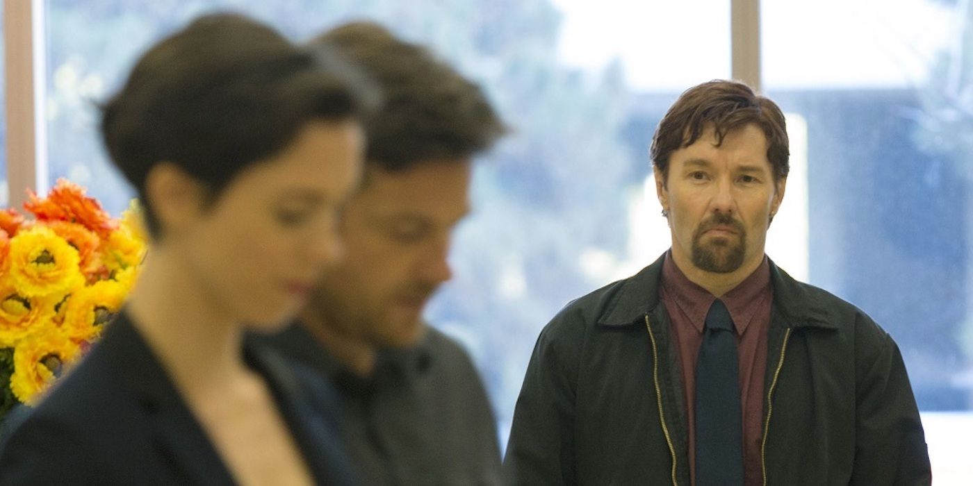 Joel Edgerton looking at Rebecca Hall and Jason Bateman in The Gift