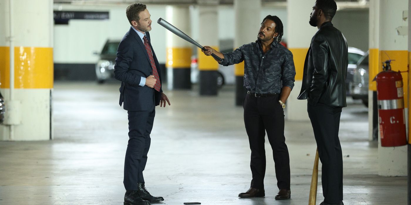 Elijah holds up a bat to Wesley