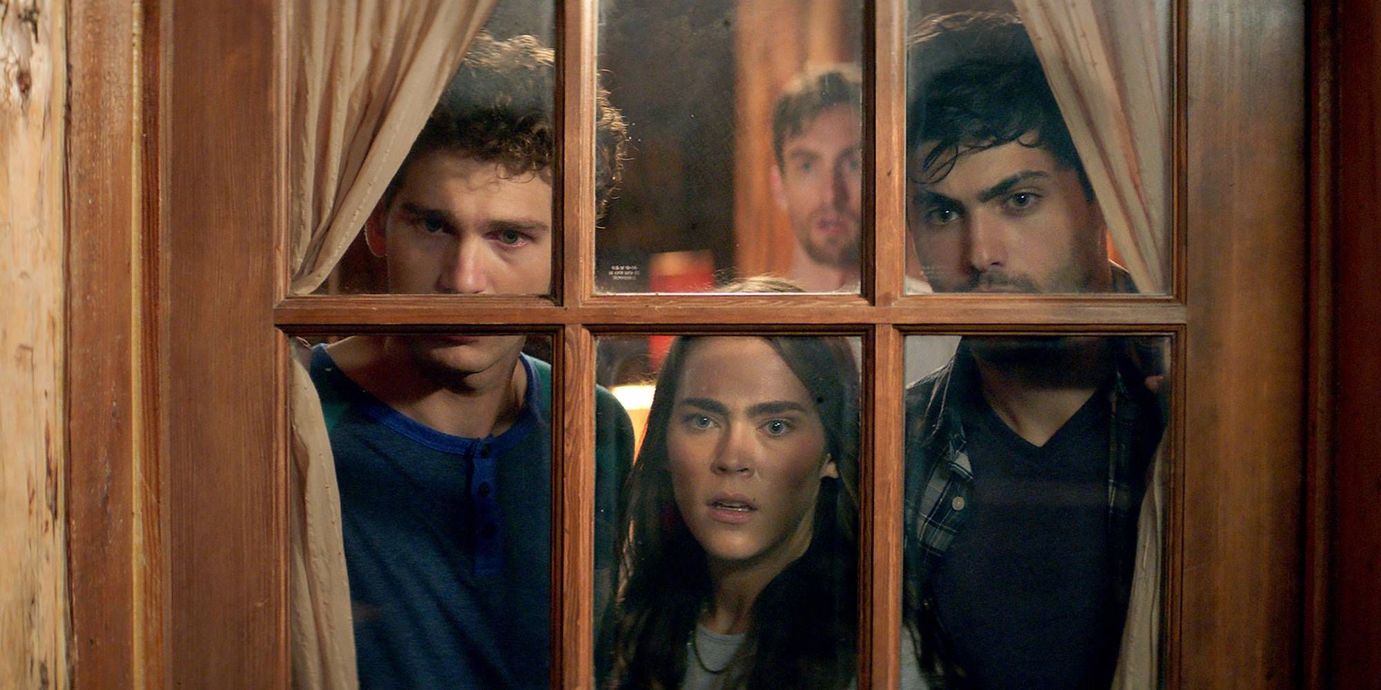 Four young people looking through a window in Cabin Fever