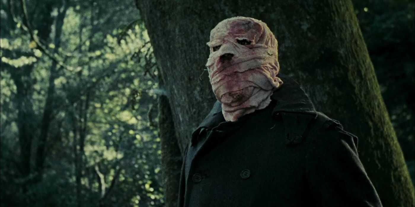 The bandaged villain stands in a forest in Timecrimes