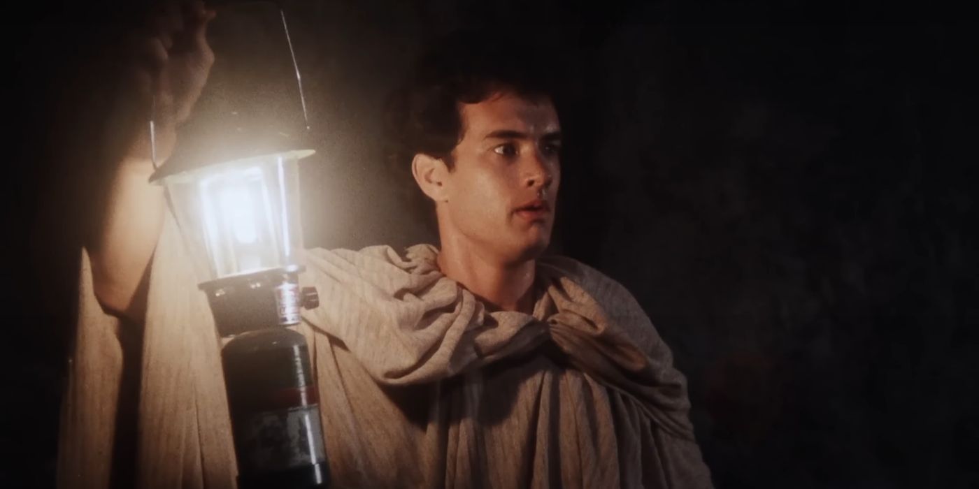 Tom Hanks as Robbie holding a lantern in 'Mazes and Monsters'