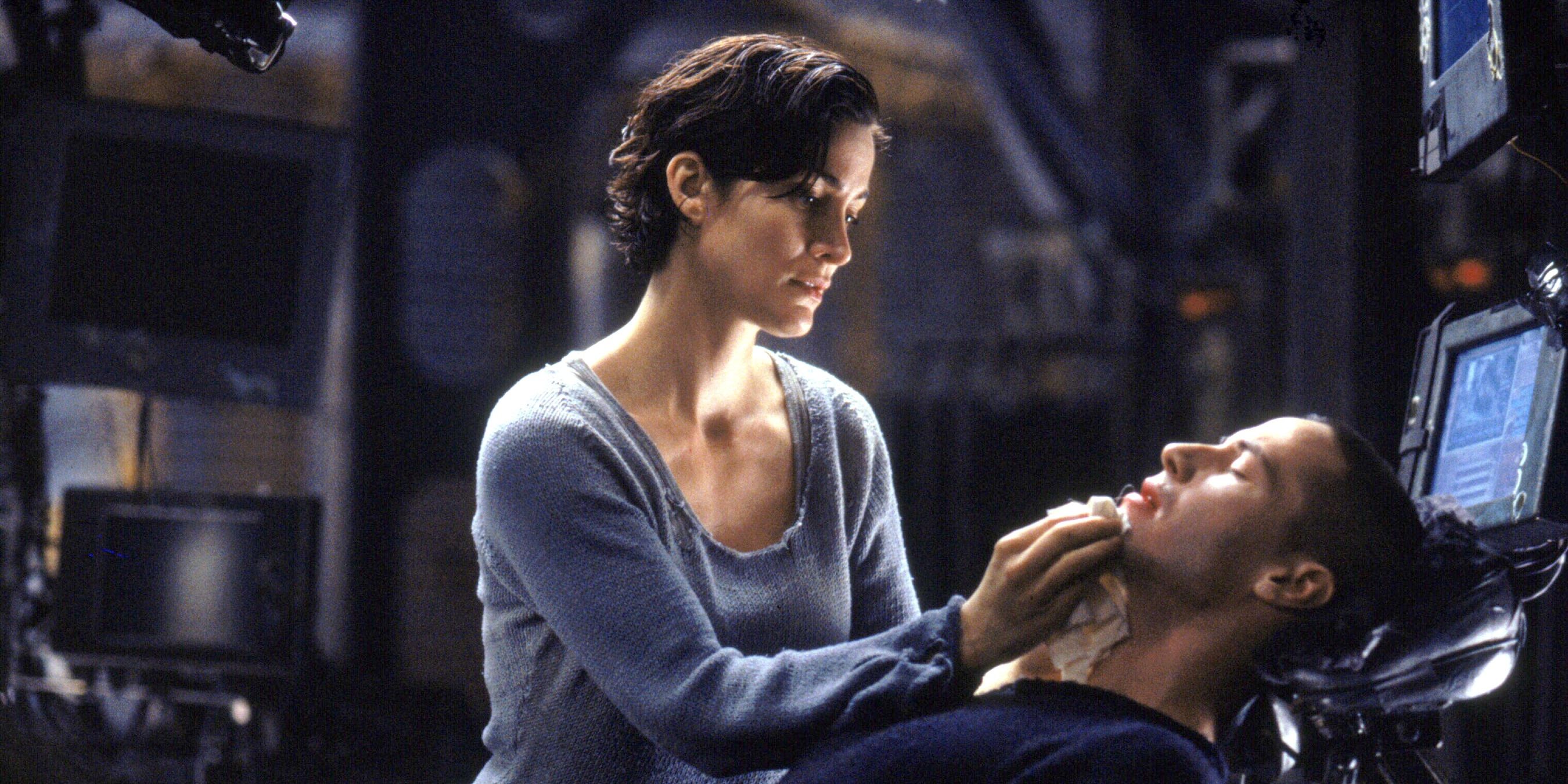 Trinity (Carrie-Anne Moss) tends to Neo (Keanu Reeves) outside of the simulation in 'The Matrix'