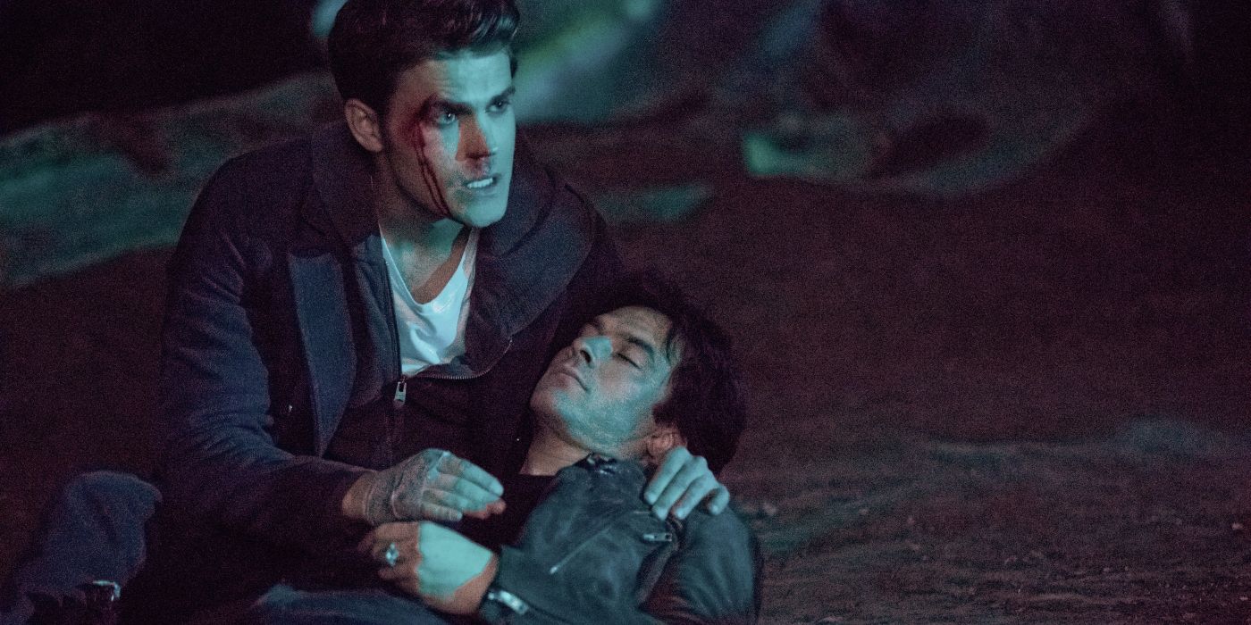 A bloodied Stefan Salvatore (Paul Wesley) holds an unconscious Damon (Ian Somerhalder) in The Vampire Diaries