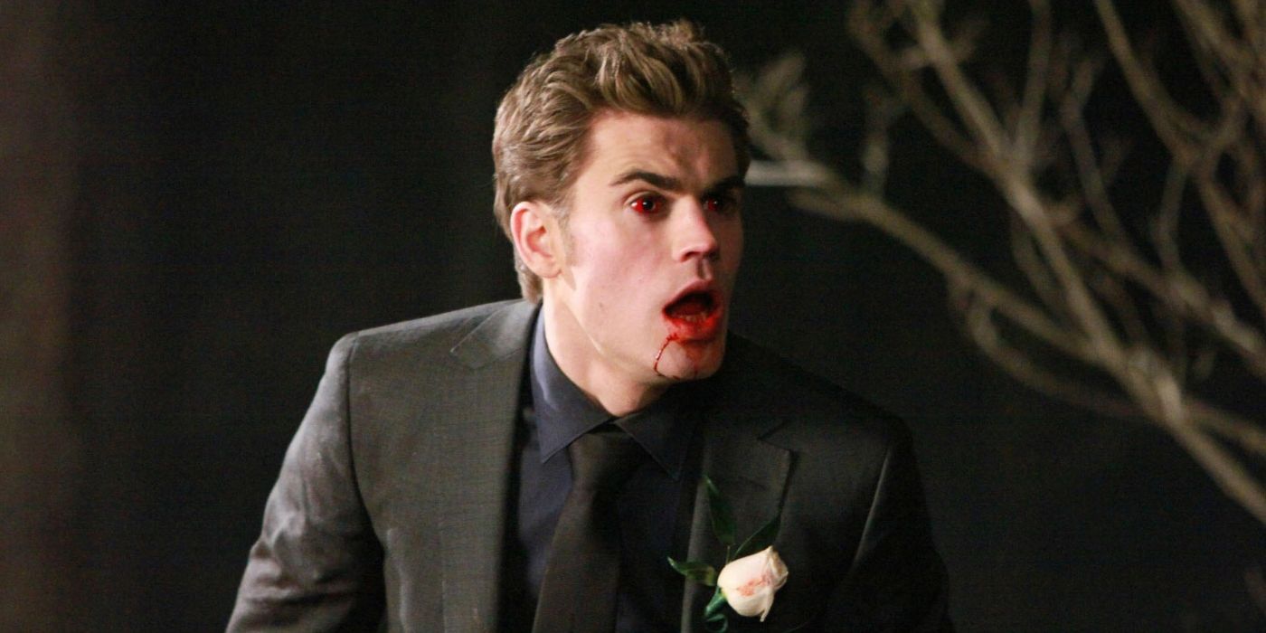 Stefan Salvatore (Paul Wesley) wearing a suit, with red eyes and blood dripping down his chin in Season 1 of The Vampire Diaries