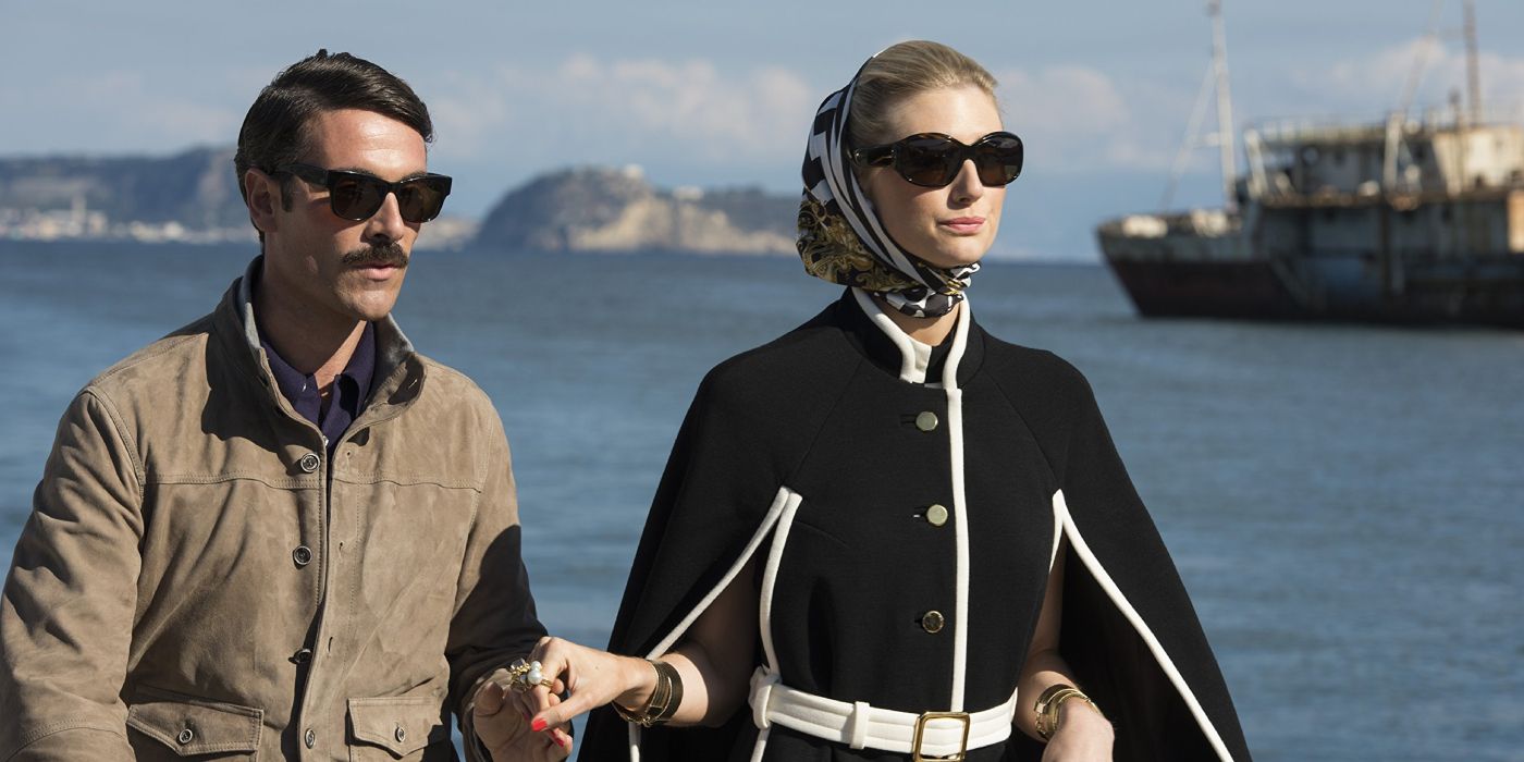 Victoria & Alexander Vinciguerra (Luca Calvani and Elizabeth Debicki) hold hands as they walk along the coast in 'The Man from U.N.C.L.E.' (2015)