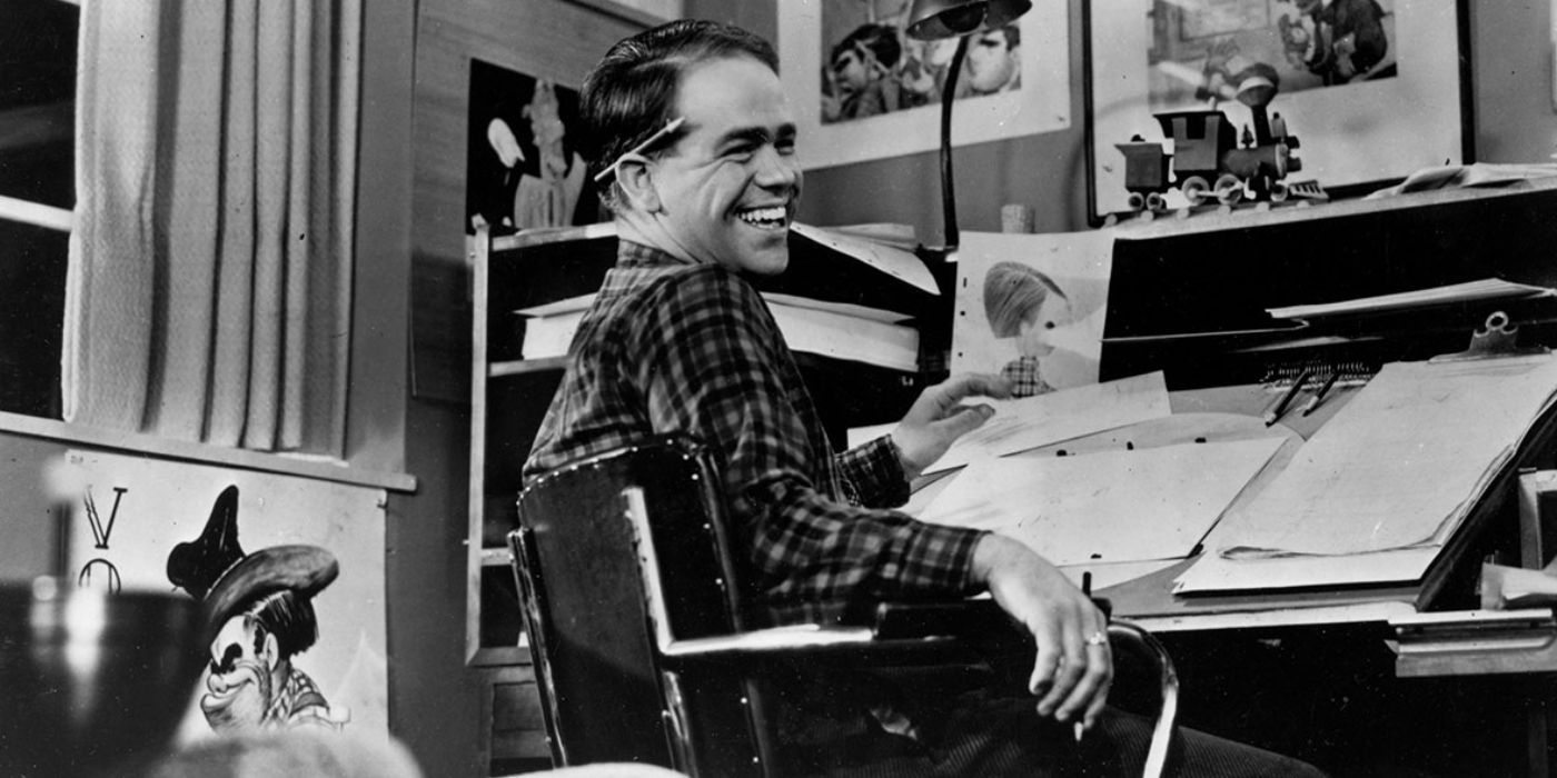 Ward Kimball smiling at his desk