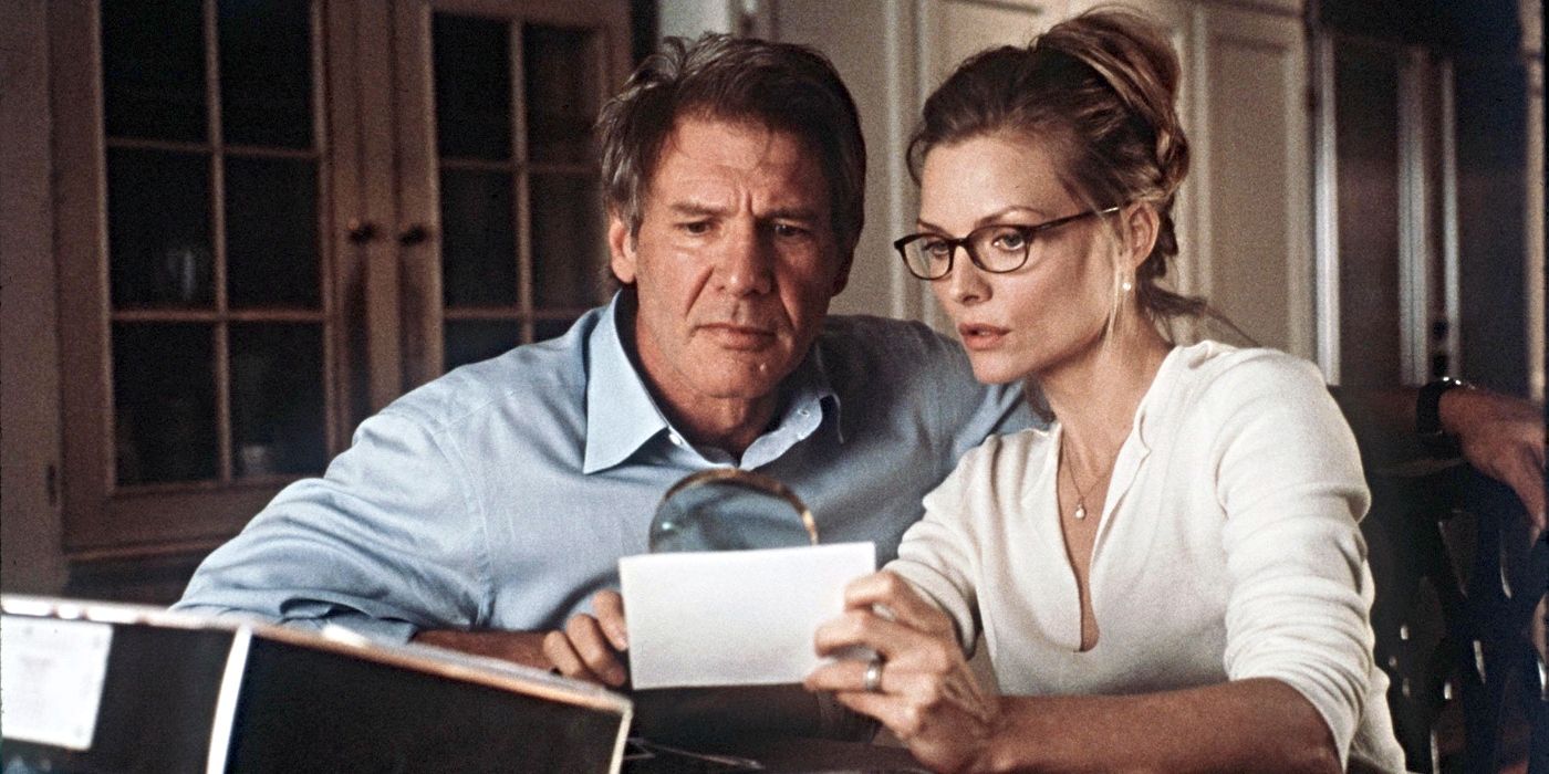 Norman (Harrison Ford) & Claire Spencer (Michelle Pfeiffer) looking at a photograph in What Lies Beneath