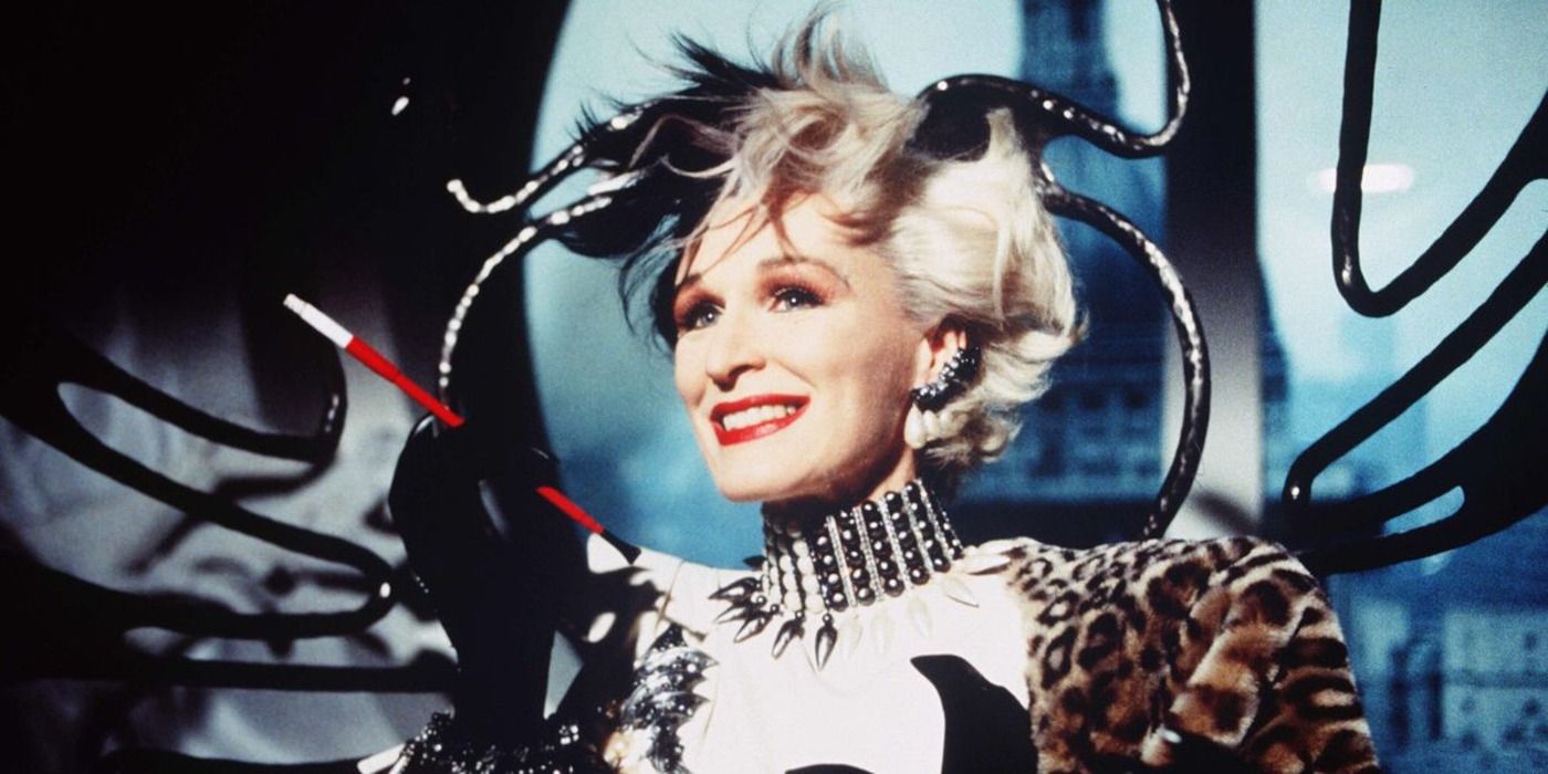 Glenn Close as Cruella de VIl smiling while holding her cigarrette in 101 Dalmatians.