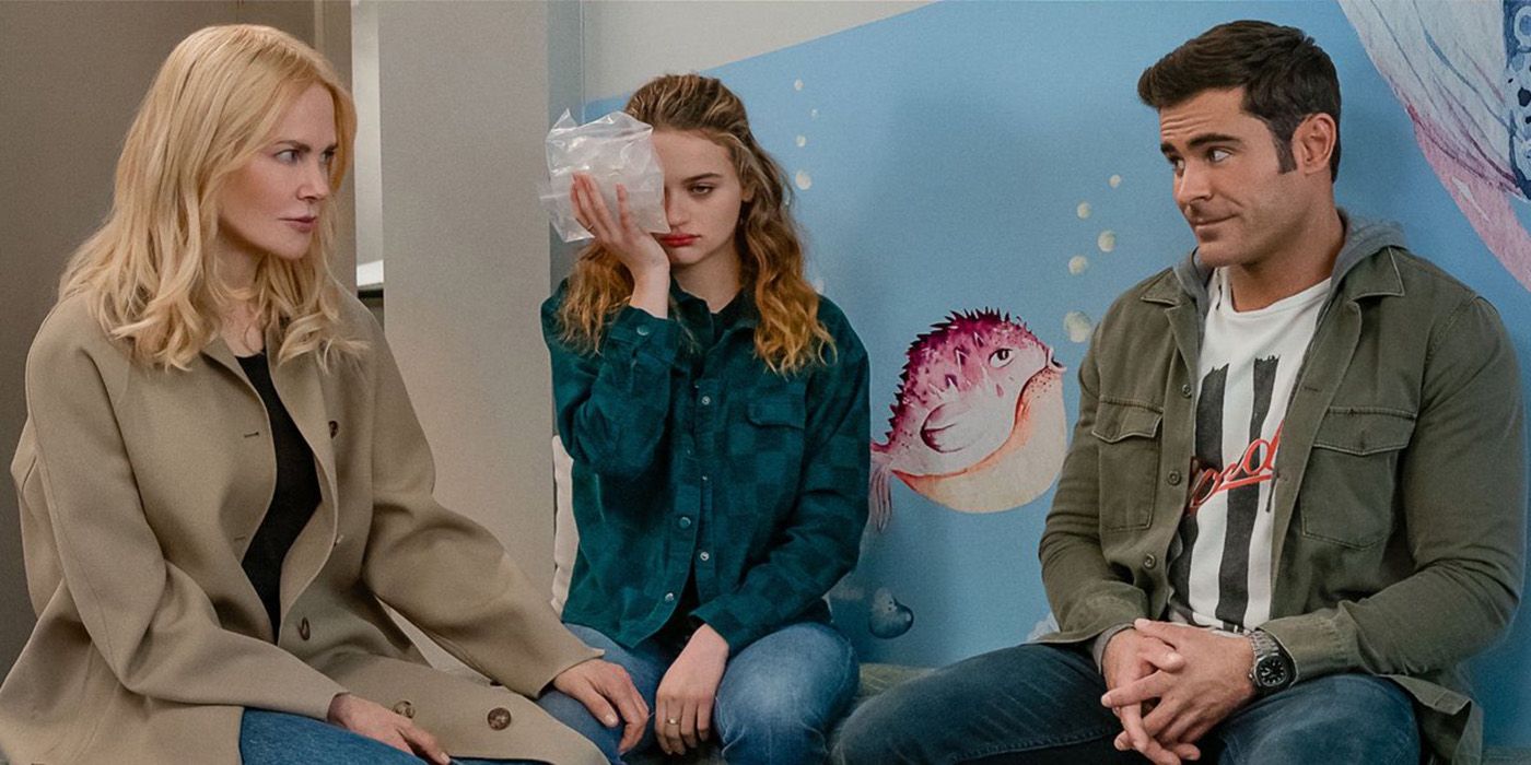 Zac Efron and Nicole Kidman sitting on either side of Joey King who has an ice pack on her face in The Family Affair