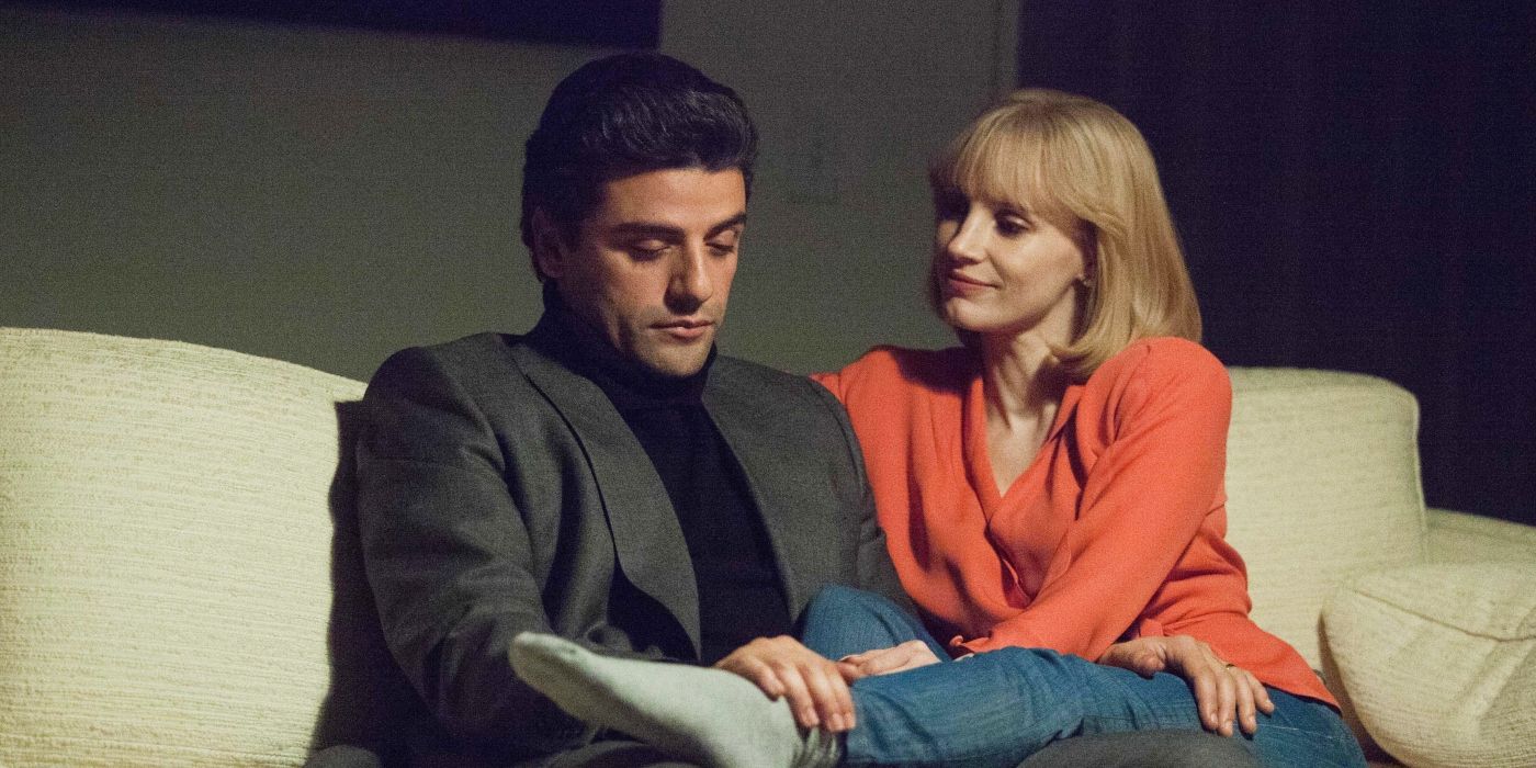 Abel and Anna sitting on the couch talking in A Most Violent Year 