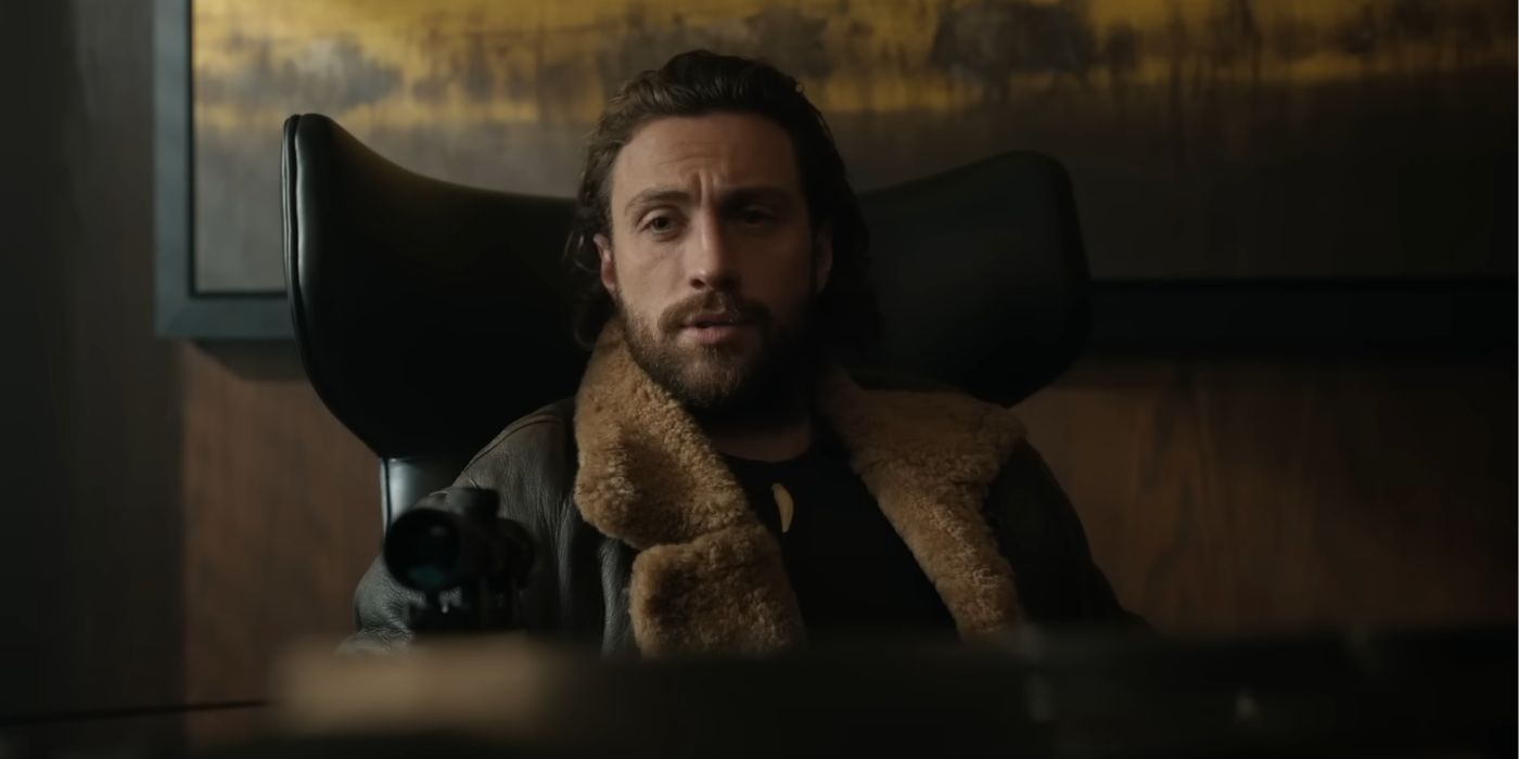 Aaron Taylor-Johnson, holding a crossbow while sitting in an office chair, as the titular character in Kraven the Hunter.