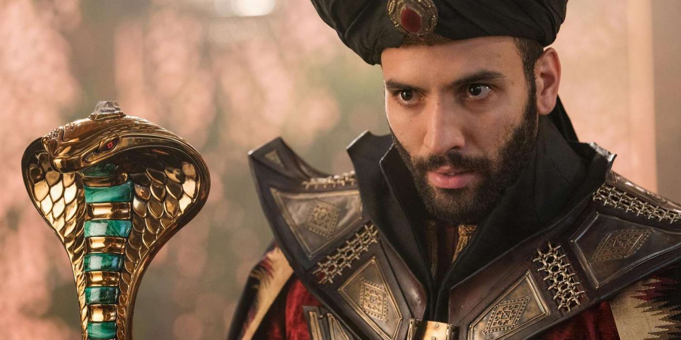 Jafar (Marwan Kenzari) stands in an extravagant set of armor while holding a snake spectre in &lsquo;Aladdin&rsquo; (2019).