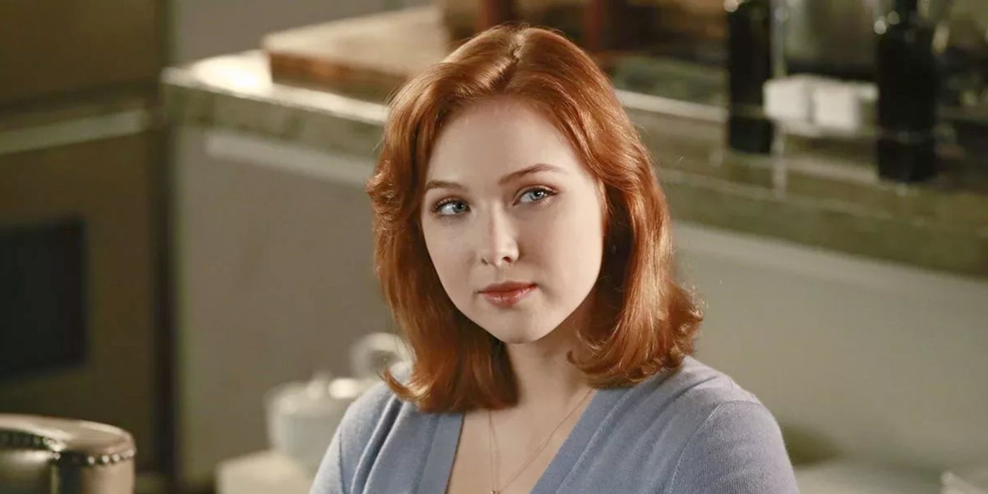 Molly Quinn as Alexis Castle, smiling and wearing a blue sweater in Castle
