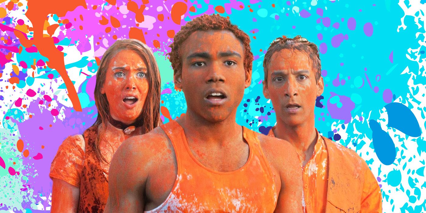 Annie (Alison Brie), Troy (Donald Glover), and Abed (Danny Pudi) of Community, covered in orange paint from a paintball fight, superimposed on a backdrop of paint splatters