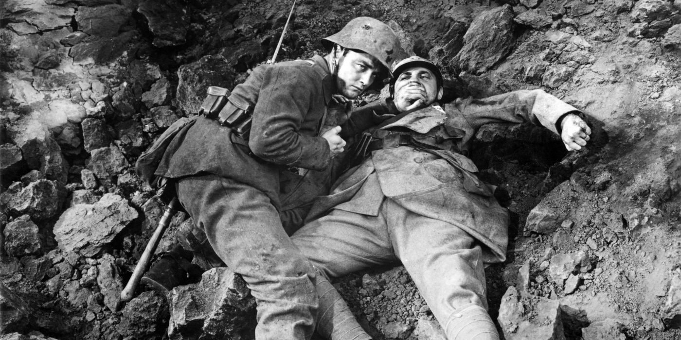 Paul (left) lays down while covering the mouth of a wounded soldier (right), who is also lying down