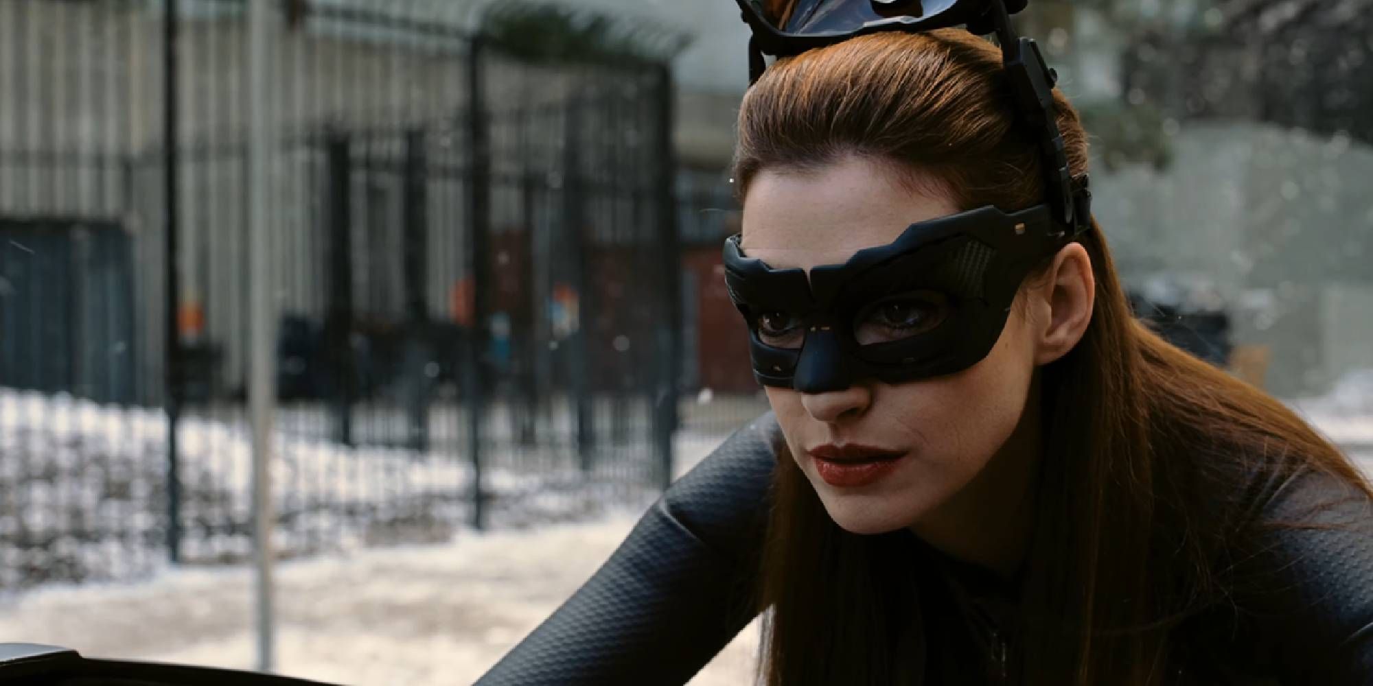 Anne Hathaway as Selina Kyle driving a motorcycle in The Dark Knight Rises close-up shot.