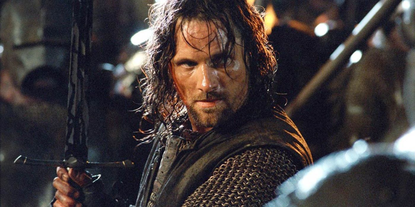 aragorn (Viggo Mortensen) stands with his sword raised, covered in orc blood