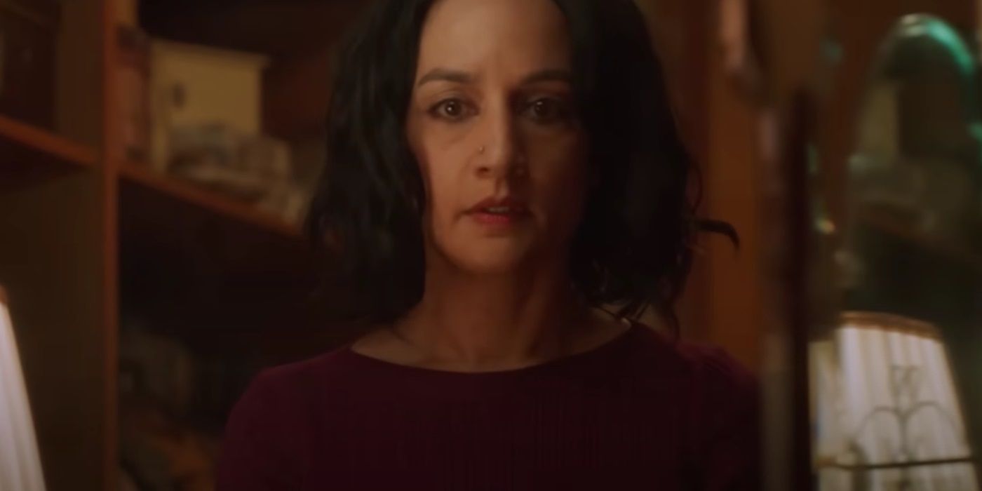 Archie Panjabi, wearing a red shirt and looking worriedly as Suman Virk, in Under the Bridge