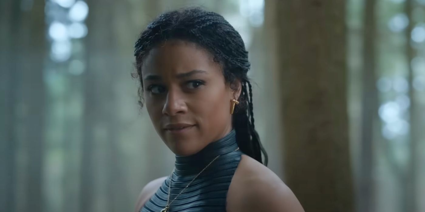 Ariana DeBose, looking concerned while standing in the forest.