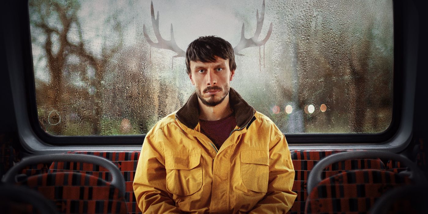 Richard Gadd, sitting in the backseat of a bus, with reindeer antlers reflecting from the back window onto the side of his head.