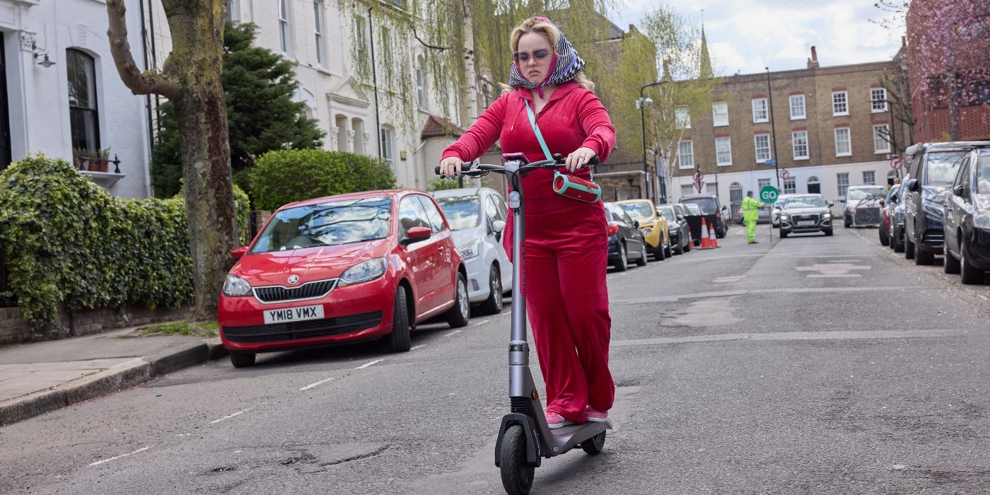 Nicola Coughlan riding a scooter in Tubi's Big Mood