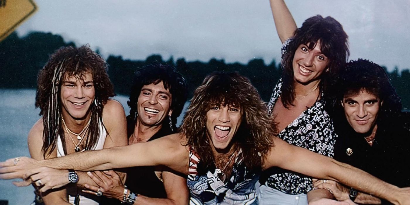 Bon Jovi members in front of a lake holding each others arms and smiling in throwback image.