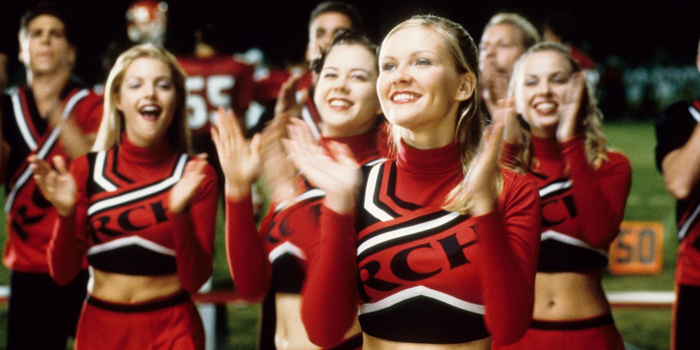 Torrance clapping next to other cheerleaders in Bring It On.